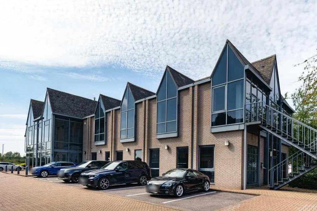 Freyberg House, Crabtree Office Village, Egham: two-storey brick office building with gabled glazed bays, external staircase and parking