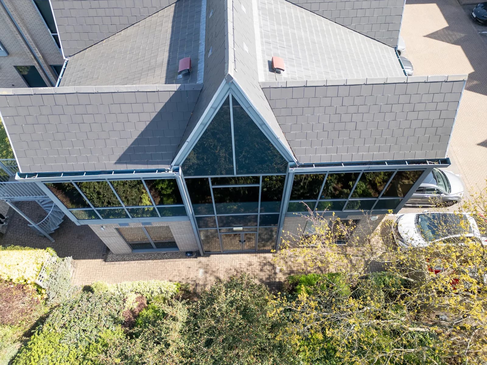 Aerial view of Freyberg House, Crabtree Office Village, Egham, showing its slate roof and full-height glazed entrance